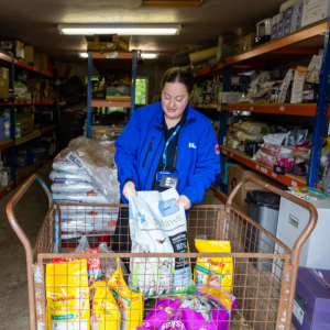 Volunteer lifting pet food