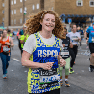 Women running in the London Marathon wearing RSPCA bib